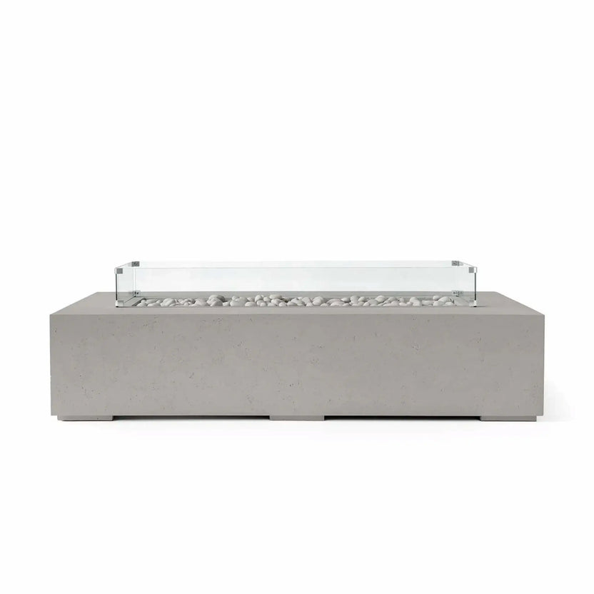 HPC Fire Hearth Products Controls Dekko GFRC Concrete Sonoma 72 x 33 Fire Pit in Sandstone finish with decorative ivory fire stones and a clear tempered glass wind guard. The warm-toned concrete exterior, clean rectangular shape, and modern fire media presentation create an inviting outdoor fire feature perfect for patios, outdoor seating areas, and contemporary landscape settings.