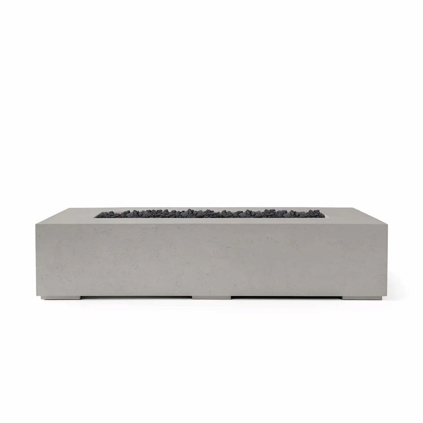 Studio product photograph of the HPC Fire & Hearth Products Dekko Sonoma 72 x 33 GFRC Concrete Fire Pit finished in Sandstone and paired with Lava Rock fire media. The elongated rectangular fire pit showcases clean lines, a modern low-profile silhouette, and a recessed burner channel filled with rugged black lava rock. Set against a white background, this image emphasizes the contrast between the warm sandstone concrete finish and the dark volcanic fire media for contemporary outdoor living environments.