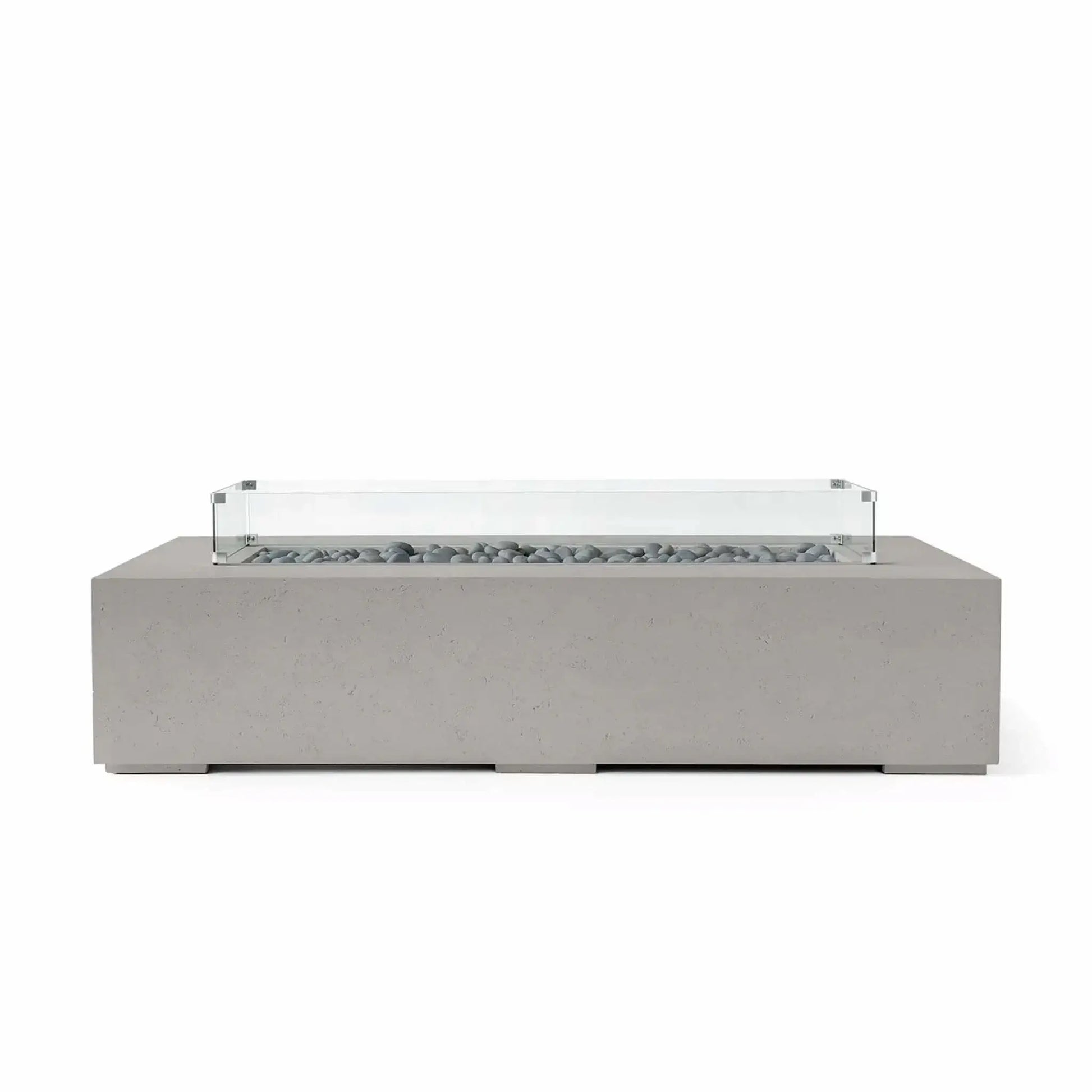 HPC Fire Hearth Products Controls Dekko GFRC Concrete Sonoma 72 x 33 Fire Pit in Sandstone finish with smooth gray slate stone fire media and a clear tempered glass wind guard. The elongated concrete fire feature showcases a contemporary architectural design with a durable construction that enhances modern outdoor living areas, patios, and residential landscape projects.