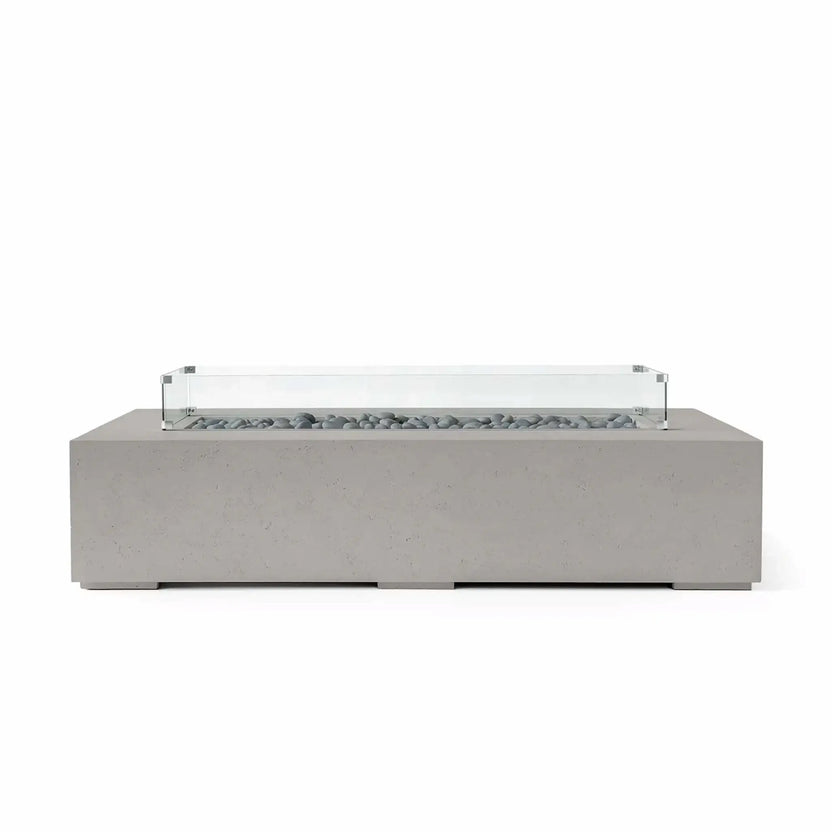 HPC Fire Hearth Products Controls Dekko GFRC Concrete Sonoma 72 x 33 Fire Pit in Sandstone finish with smooth gray slate stone fire media and a clear tempered glass wind guard. The elongated concrete fire feature showcases a contemporary architectural design with a durable construction that enhances modern outdoor living areas, patios, and residential landscape projects.