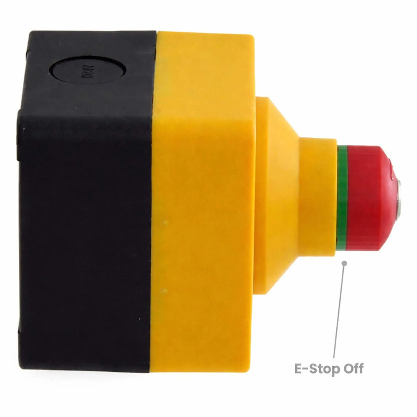 Side view of the emergency stop control unit in the deactivated or reset position, with the red button pushed inward and a green ring visible. The compact yellow and black housing demonstrates its ready-to-operate state, commonly used for commercial fire pit systems or electrical safety controls.