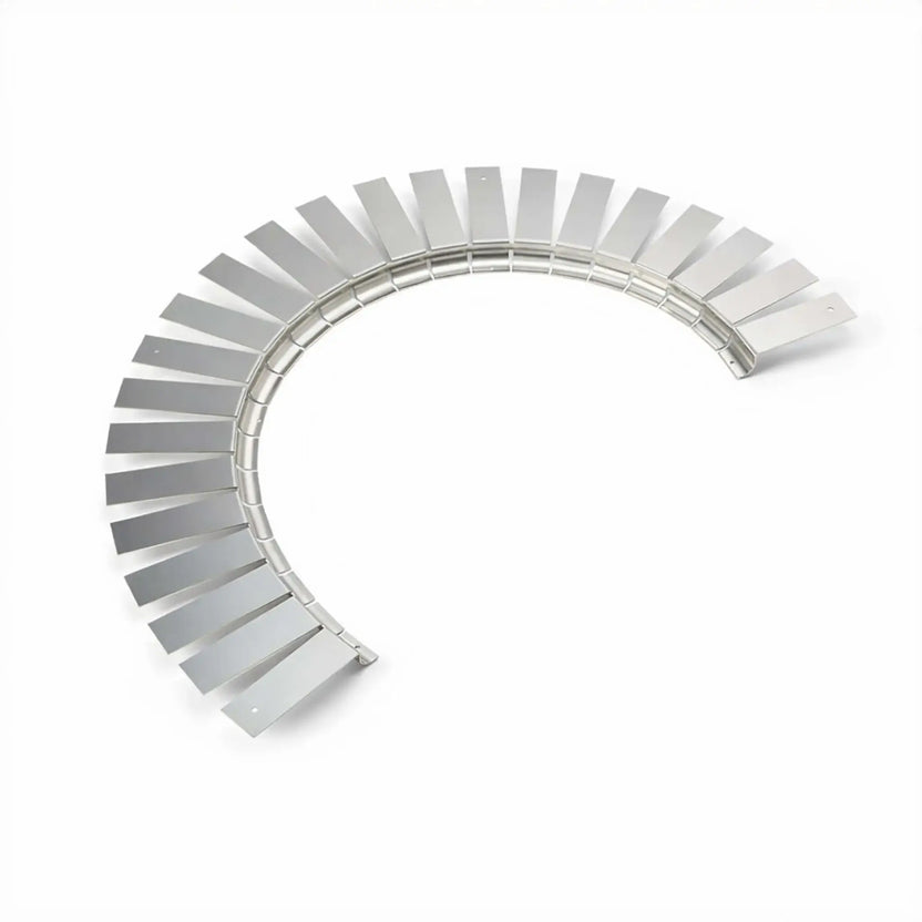 Top view of the flexible stainless steel fire pit installation collar arranged in a curved shape on a clean white background. The evenly spaced rectangular tabs and continuous hinge-like structure demonstrate its ability to form circular or custom-shaped fire pit openings for insert support.