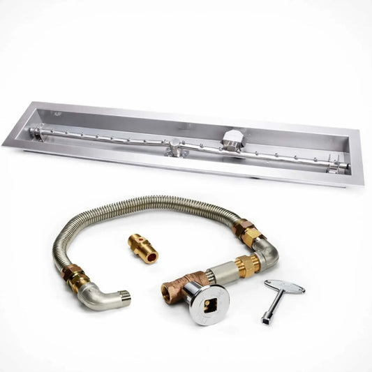 HPC Fire Hearth Products Controls fire pit ignition insert shown on a white background, featuring a high capacity match lit ignition system with a stainless steel linear trough drop in pan and torpedo burner. The kit includes a flexible gas line, brass fittings, shut off valve, and ignition key, clearly highlighting the components of this linear fire pit burner system.