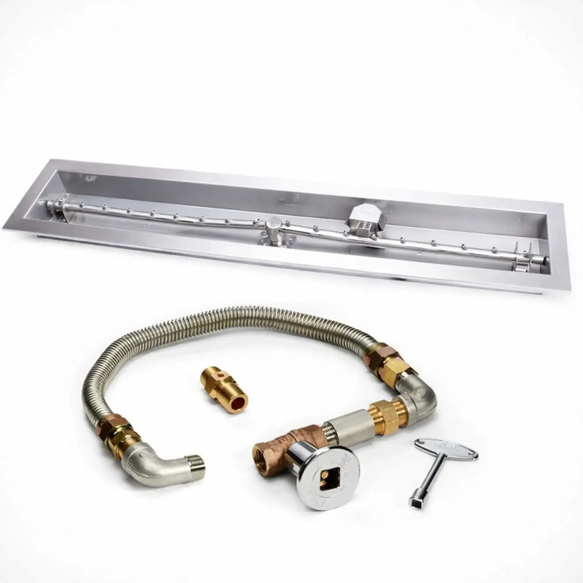 HPC Fire Hearth Products Controls fire pit ignition insert shown on a white background, featuring a high capacity match lit ignition system with a stainless steel linear trough drop in pan and torpedo burner. The kit includes a flexible gas line, brass fittings, shut off valve, and ignition key, clearly highlighting the components of this linear fire pit burner system.