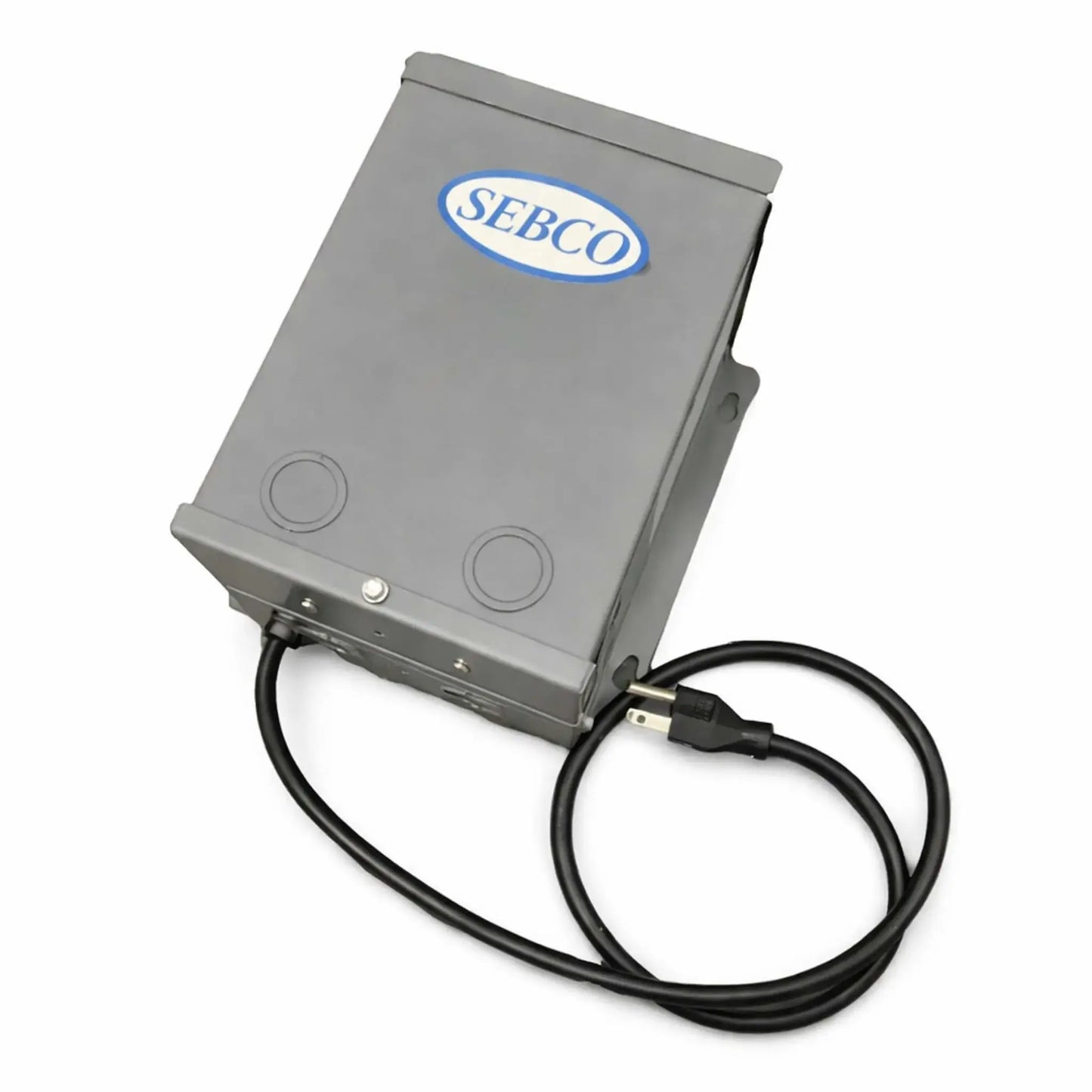 Product image of a SEBCO magnetic transformer housed in a durable gray metal enclosure with a hinged cover and mounting tabs. The unit features a prewired black power cord with a standard plug and knockout ports on the front for electrical connections. Designed for fire pit ignition systems, this low-voltage power supply is suitable for indoor or outdoor use and built for reliable performance in ignition control setups.