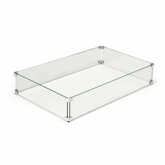 Rectangular tempered glass wind guard for outdoor fire pit tables displayed on a clean white background. The clear glass panels are secured with polished metal corner brackets and supports, designed to shield flames from wind while maintaining a sleek, modern appearance for linear gas fire features.