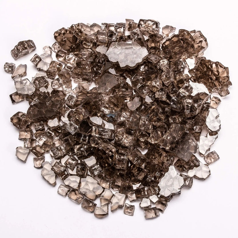 A pile of bronze-colored tempered fire glass with warm, smoky tones displayed on a white surface. The translucent pieces catch light subtly, creating depth and richness, making it a popular choice for adding a cozy, upscale feel to fire features.