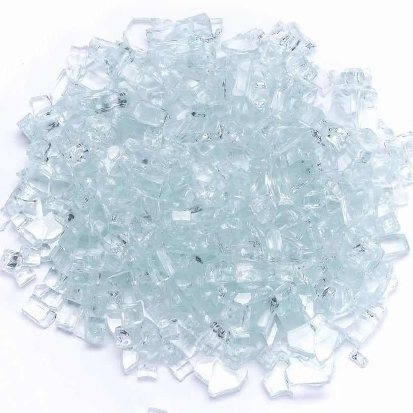 Clear tempered fire glass pieces spread across a white background, featuring a soft, icy appearance with light-reflecting edges. The clean, neutral look enhances flame visibility and works well in both modern and traditional fire pit designs.