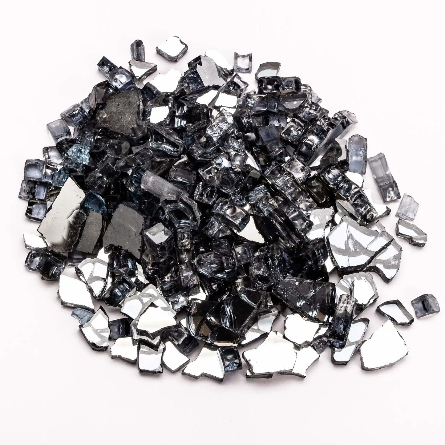 A pile of reflective gray tempered fire glass with a smoky, translucent appearance, shown on a white background. The irregular, polished pieces reflect light subtly, blending silver and charcoal tones. This fire glass offers a modern, neutral look that enhances flame visibility while maintaining a clean, upscale aesthetic.