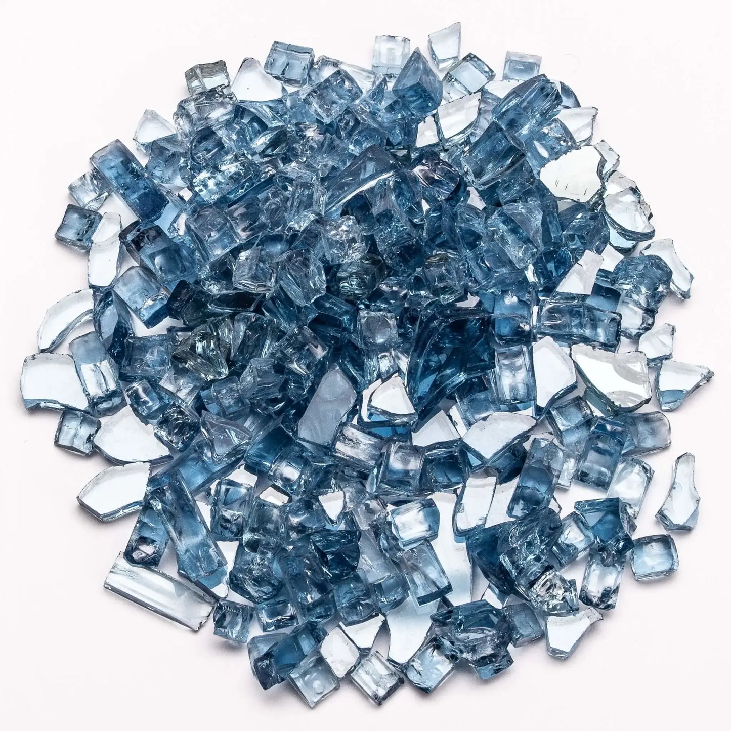 Reflective pacific blue tempered fire glass displayed in a clustered pile on a white background. The translucent blue pieces range from light aqua to deeper ocean tones, with mirrored backing that amplifies sparkle and flame reflection. Ideal for adding a vibrant, contemporary pop of color to fire pits and fireplaces.