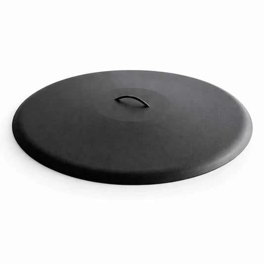 Low-profile round aluminum fire pit burner cover in a matte black finish, featuring a smooth, slightly domed surface with a subtle textured coating. A centered curved metal handle sits flush within a recessed top section for easy lifting. The clean white background highlights the minimalist design, durable construction, and modern aesthetic ideal for protecting outdoor fire pit burners.