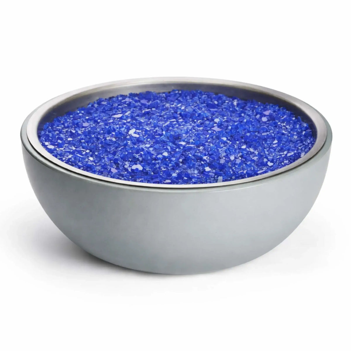 HPC Fire Inspired Hearth Products concrete aluminum fire bowl filled with reflective blue fire glass, emphasizing the sleek rounded design and decorative fire media commonly used in modern gas fire pit applications.