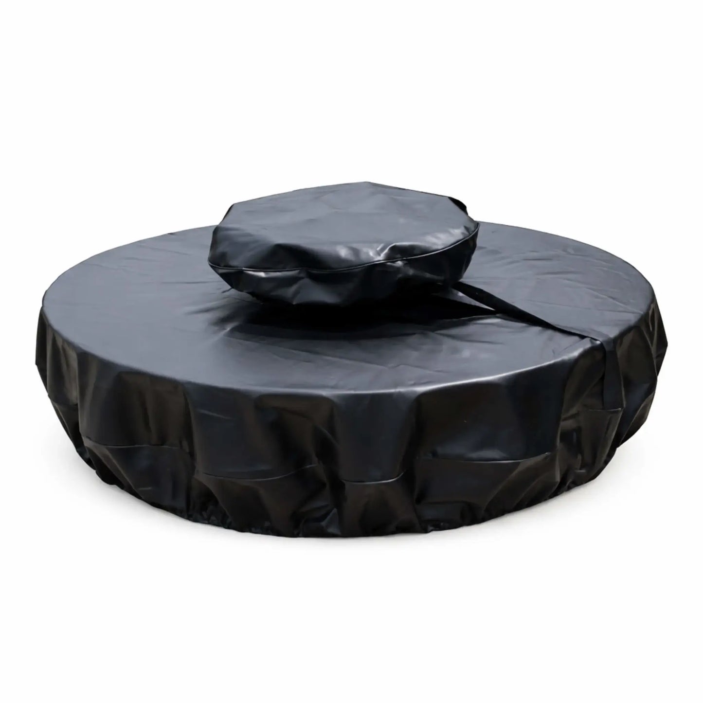Round black vinyl fire pit cover designed for a unit with a raised center section, shown on a white background. The cover features a two-tier fit with a smaller, elevated top section and a wider base cover, connected by a visible strap or seam. The material has a smooth, slightly glossy finish with natural creases and folds, while the lower edge appears gathered for a snug, secure fit, offering full protection from weather and debris.