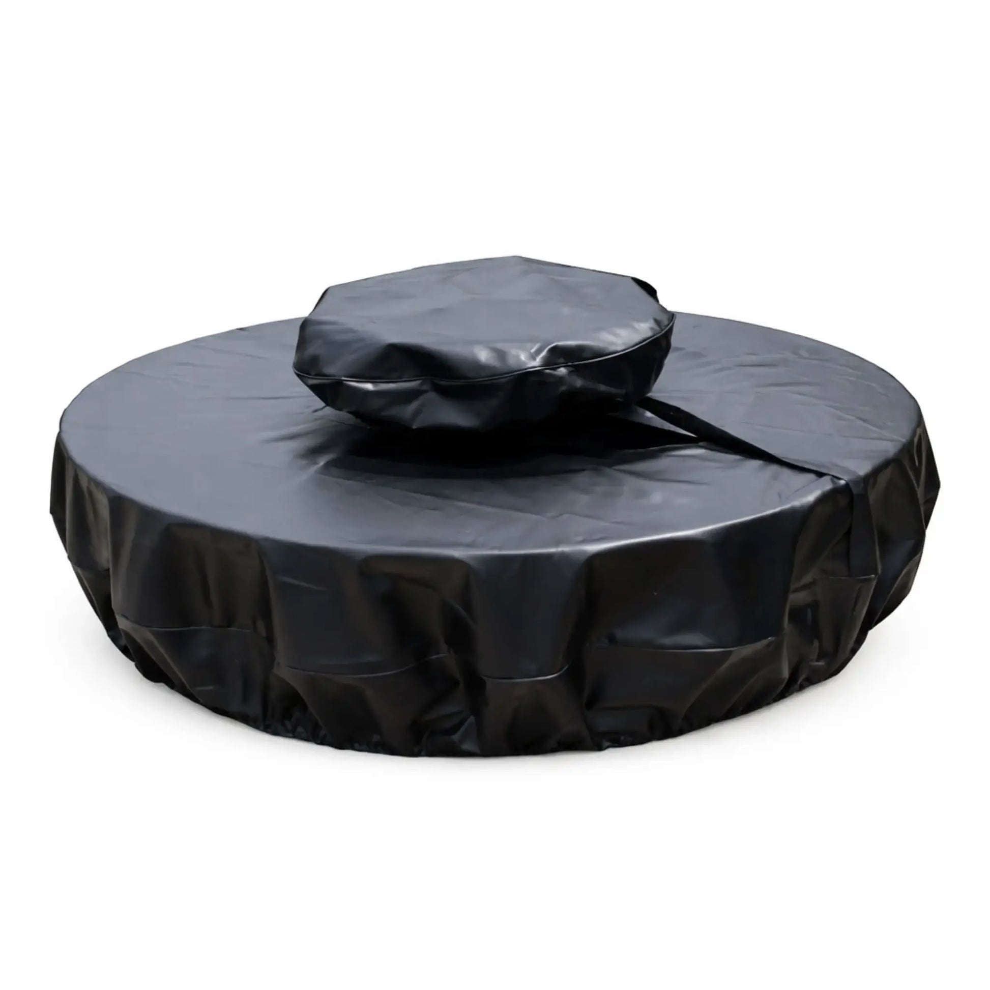 Round black vinyl fire pit cover designed for a unit with a raised center section, shown on a white background. The cover features a two-tier fit with a smaller, elevated top section and a wider base cover, connected by a visible strap or seam. The material has a smooth, slightly glossy finish with natural creases and folds, while the lower edge appears gathered for a snug, secure fit, offering full protection from weather and debris.