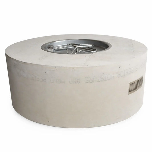 Studio product image of a round ready-to-finish fire pit table enclosure made from cement board, featuring a recessed stainless steel burner pan with a star-shaped burner. The cylindrical structure includes a smooth unfinished exterior and a built-in side vent, designed for custom finishing in outdoor patio or backyard fire feature installations.