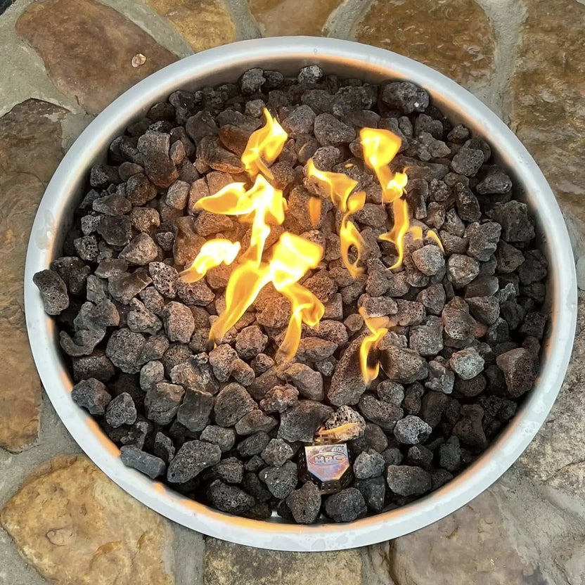 HPC Fire Inspired Hearth Products FPPK push button flame sensing penta burner shown in a top-down view of a round fire pit filled with lava rock. Bright flames rise evenly across the burner, highlighting the circular drop-in design and consistent heat distribution within the fire feature.