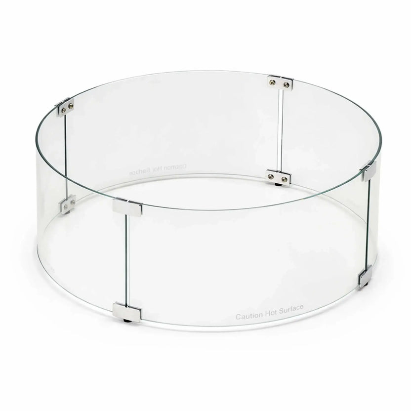 Product image of a round tempered glass wind guard for fire pits, featuring clear curved glass panels secured with stainless steel brackets. The wind guard is shown on a clean white background, highlighting its transparent design and durable construction for outdoor gas fire features.