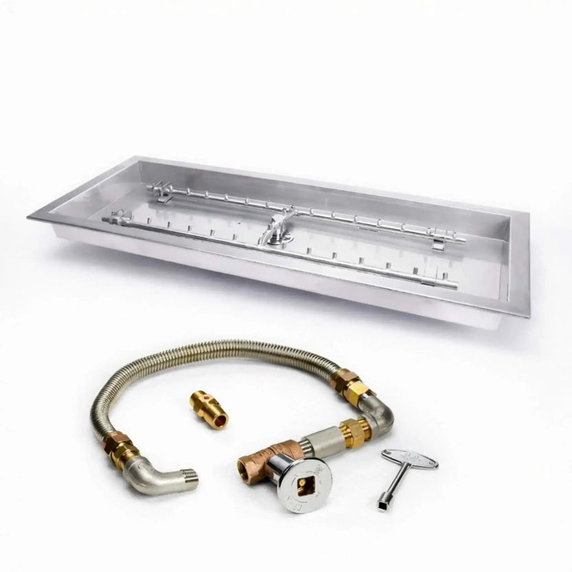 Rectangular stainless steel drop-in fire pit pan with H-style burner and torpedo ports, shown on a clean white background alongside a flexible gas line, brass fittings, shut-off valve, and key ignition. This high-capacity match-lit burner kit is designed for custom fire pit builds, offering even flame distribution and durable corrosion-resistant construction.