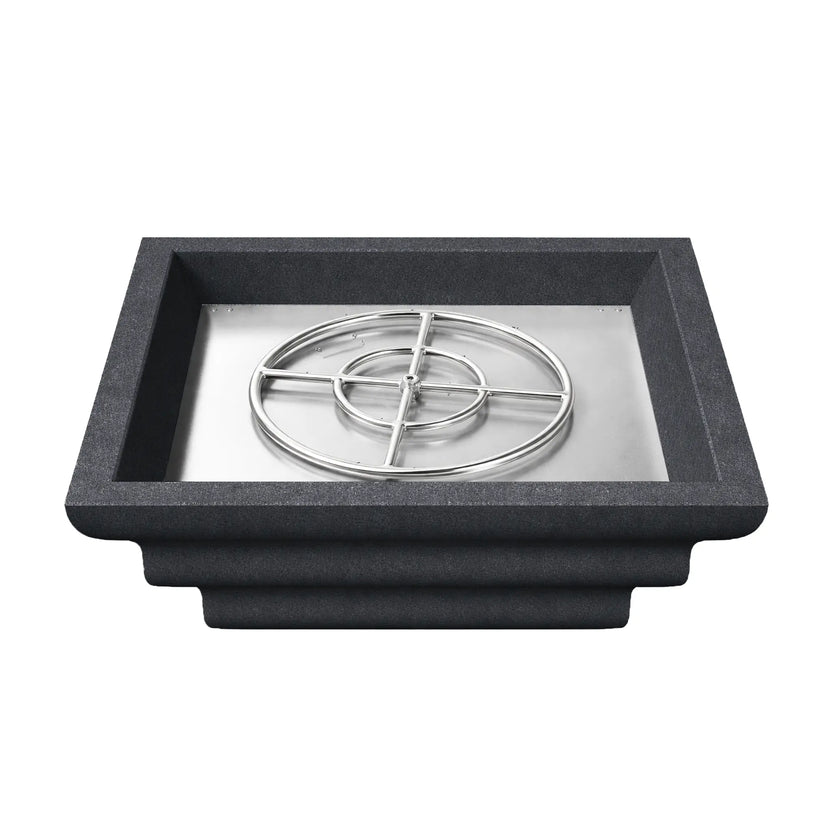 Top view of the black Shadow Cast Ripple Designer Series fire bowl filled with dark lava rock media but without flame. The square recessed burner area is packed with decorative fire rock that conceals the gas burner system beneath, highlighting the bowl’s clean square opening and textured concrete-style exterior.