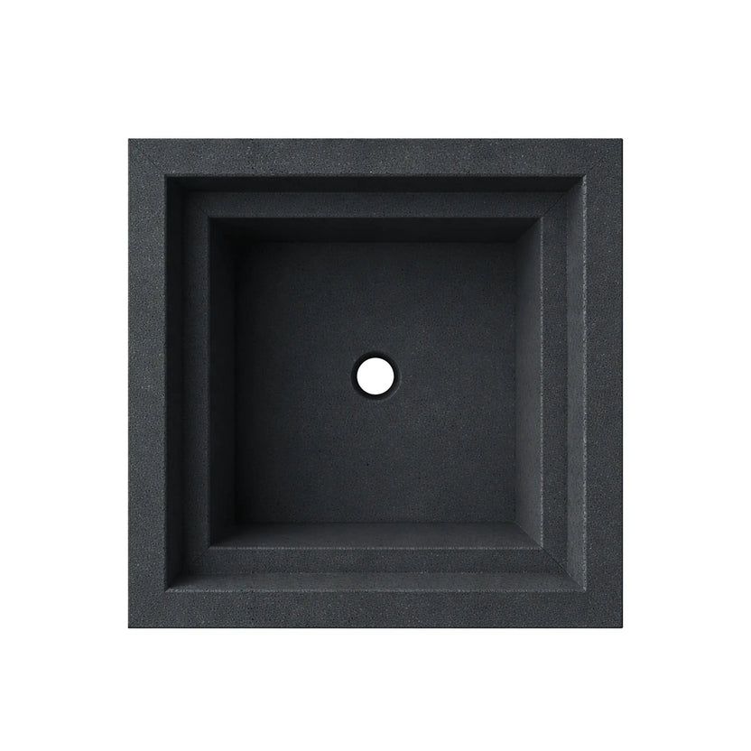 Overhead view of the empty black Shadow Cast Ripple Designer Series fire bowl showing the interior basin without burner components installed. The square fire chamber features a centered gas supply hole for burner installation and a smooth interior surface surrounded by the thick architectural rim of the bowl.