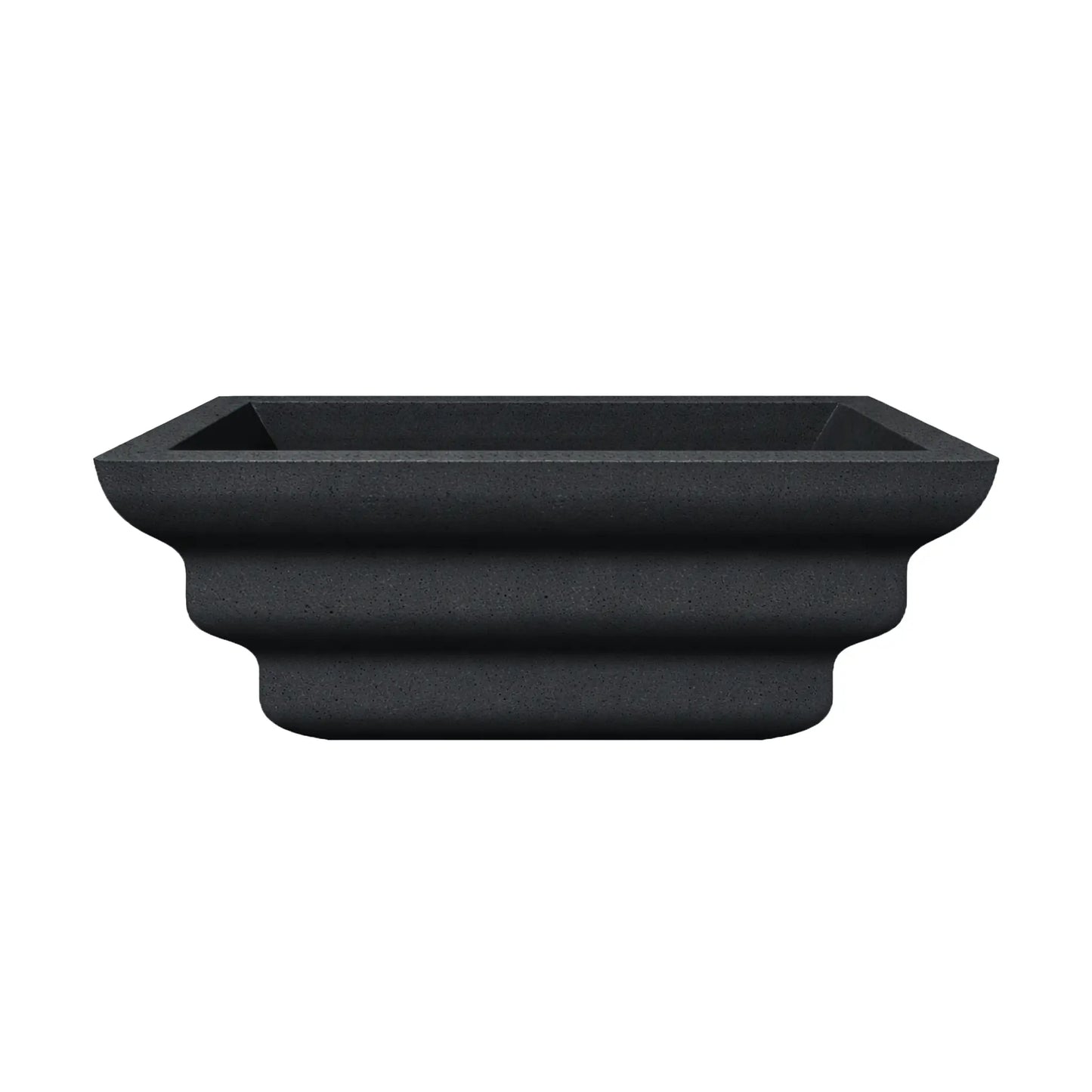 Side profile view of the black Shadow Cast Ripple Designer Series fire bowl with an empty basin. The sculpted ripple-style exterior creates layered curves that give the bowl a distinctive architectural look. The square rim and tapered base highlight the bowl’s modern outdoor fire feature design.