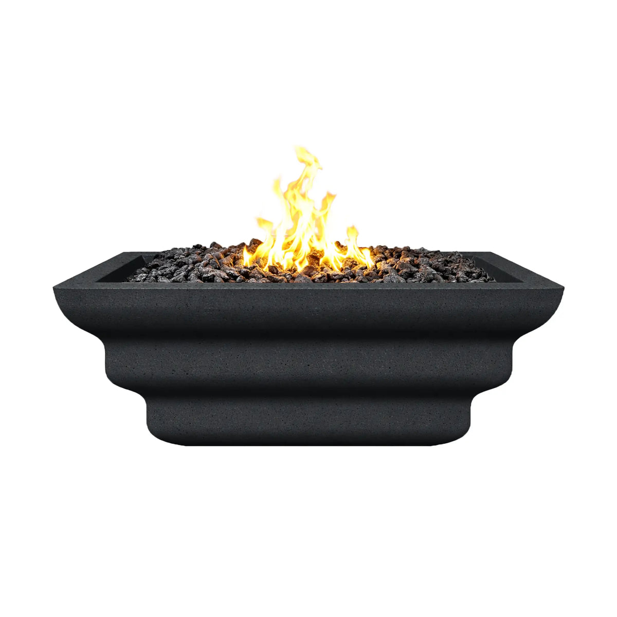 Side elevation view of the black Shadow Cast Ripple Designer Series fire bowl burning with a bright gas flame above black lava rock media. The layered ripple pattern along the exterior is clearly visible, giving the square fire bowl a sculpted architectural look suitable for luxury outdoor fire pit installations.