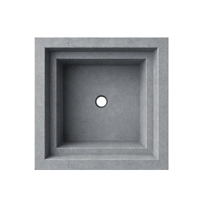 Top-down view of the gray Shadow Cast Ripple Designer Series square fire bowl with an empty interior basin. The recessed square chamber shows a centered circular gas inlet opening for burner installation. The bowl features a textured concrete-style gray finish and stepped inner ledge design, highlighting the clean geometric layout of this outdoor gas fire feature.