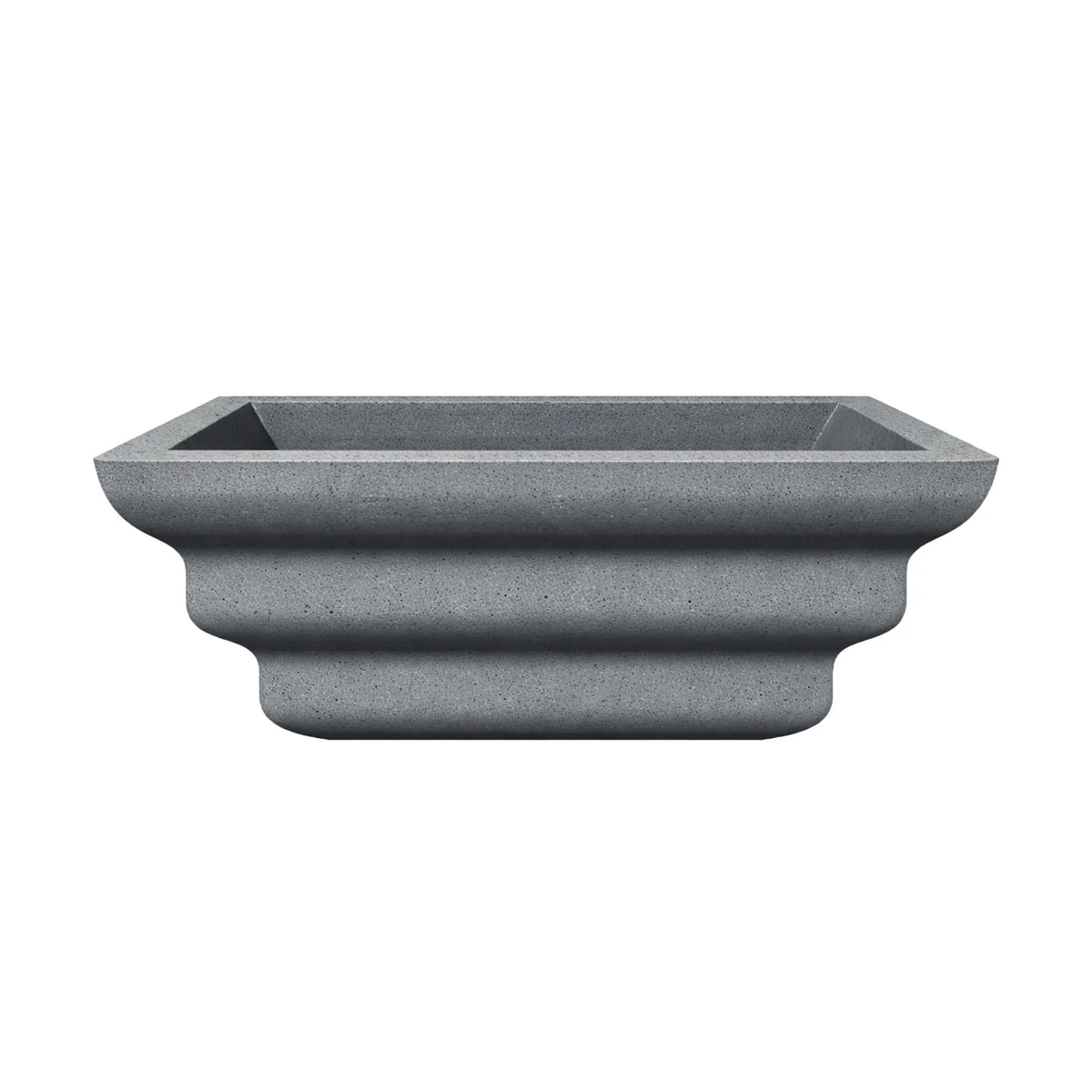 Side profile of the gray Shadow Cast Ripple Designer Series fire bowl with no burner or media installed. The sculpted ripple-style exterior creates three layered curves along the base, giving the bowl a distinctive architectural look. The square top opening and textured gray finish emphasize its modern outdoor fire feature design.