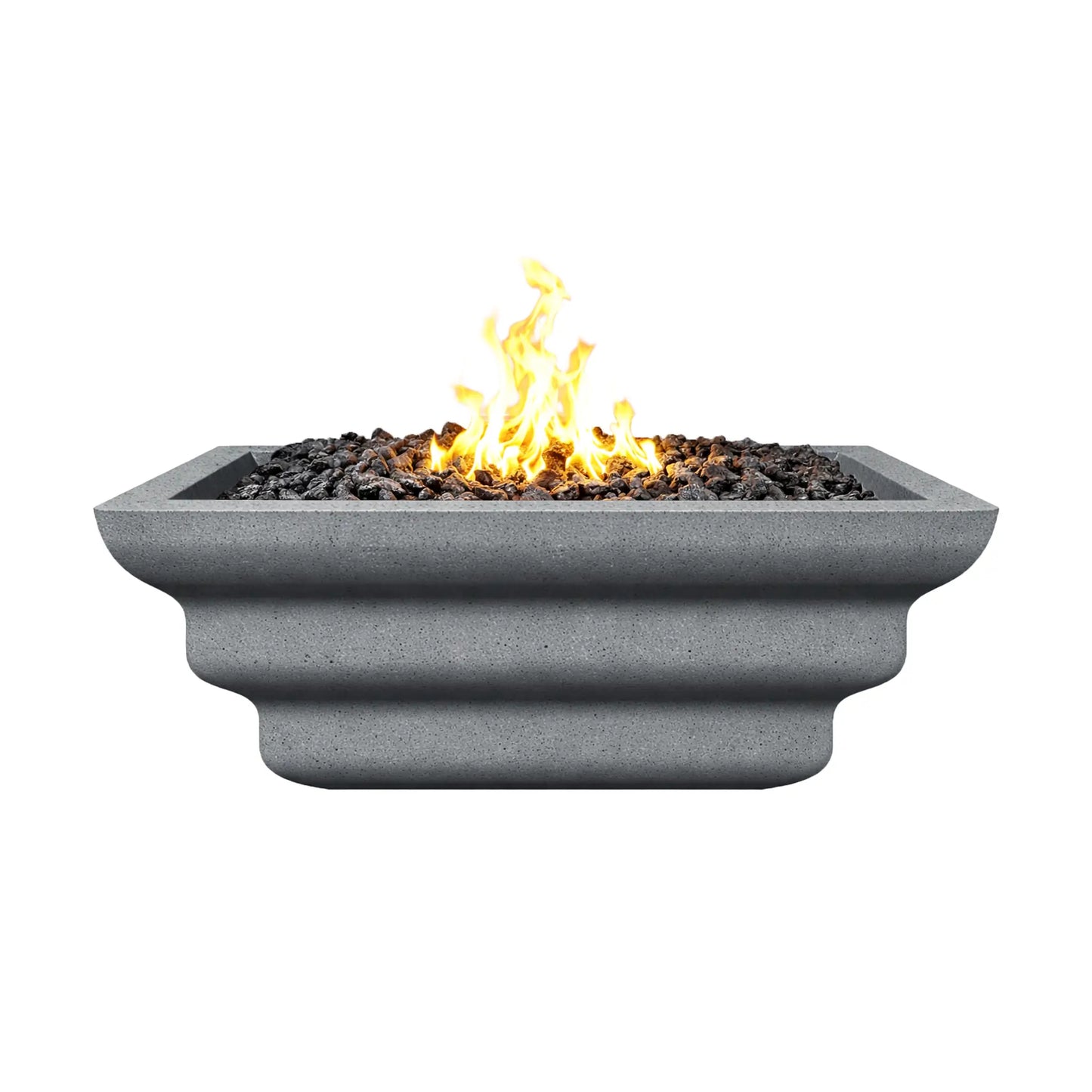 Side view of the gray Shadow Cast Ripple Designer Series fire bowl burning with a bright yellow gas flame above black lava rock media. The bowl’s ripple-style sculpted sides and square rim are visible, while the textured gray concrete-like finish gives the fire feature a modern architectural appearance suitable for outdoor patios and landscape installations.