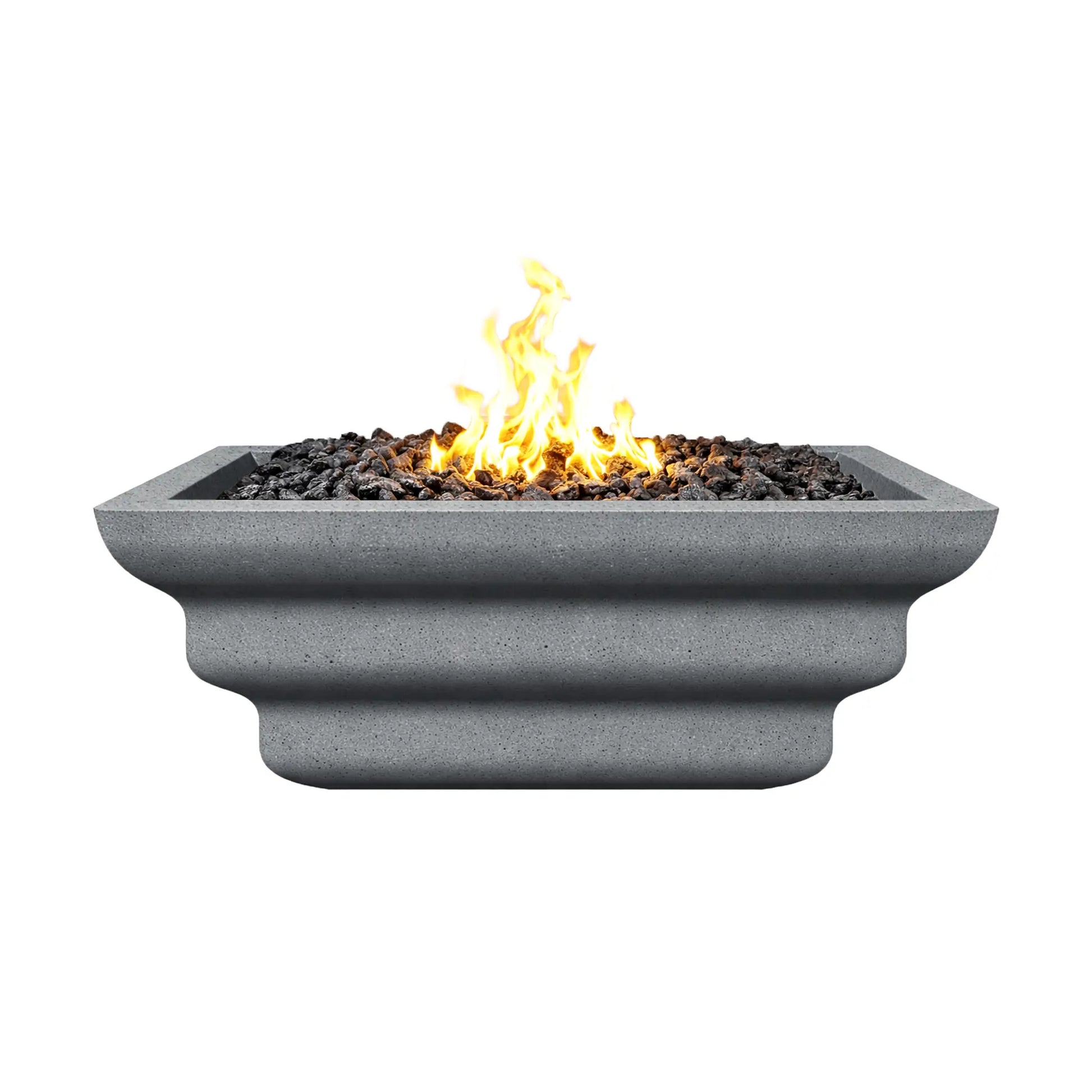 Side view of the gray Shadow Cast Ripple Designer Series fire bowl burning with a bright yellow gas flame above black lava rock media. The bowl’s ripple-style sculpted sides and square rim are visible, while the textured gray concrete-like finish gives the fire feature a modern architectural appearance suitable for outdoor patios and landscape installations.