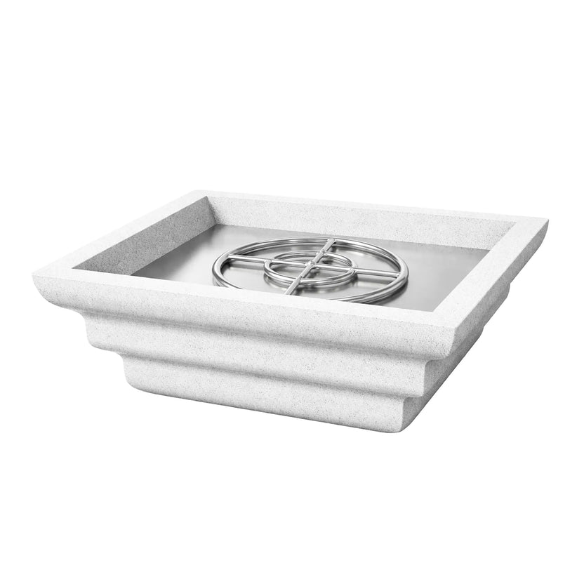 Angled view of the white Shadow Cast Ripple Designer Series fire bowl without flame. Inside the square recessed basin, a stainless steel burner ring and metal burner pan are visible, showing the gas fire system components. The bowl’s textured white finish and ripple-style sculpted sides add a contemporary architectural touch.