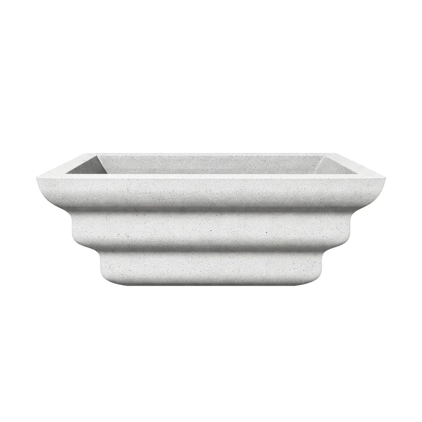 Side profile view of the white Shadow Cast Ripple Designer Series fire bowl with an empty basin. The exterior displays a layered ripple-style sculpted design that creates three rounded horizontal contours along the base. The textured white finish and square rim give the bowl a modern architectural appearance for outdoor fire features.