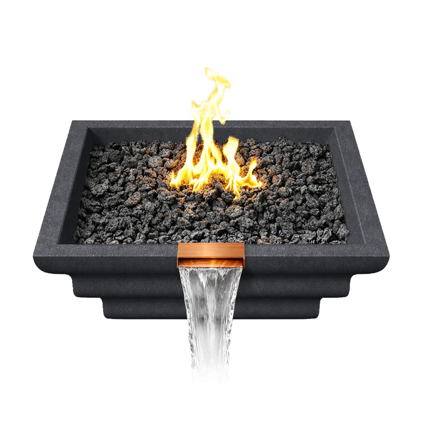 Top-down perspective of the graphite Ripple Designer Series fire and water bowl showing black lava rock fire media surrounding an active gas flame. The square concrete basin frames the fire feature while a copper waterfall spillway at the front pours a steady stream of water downward, highlighting the combination fire and water effect.