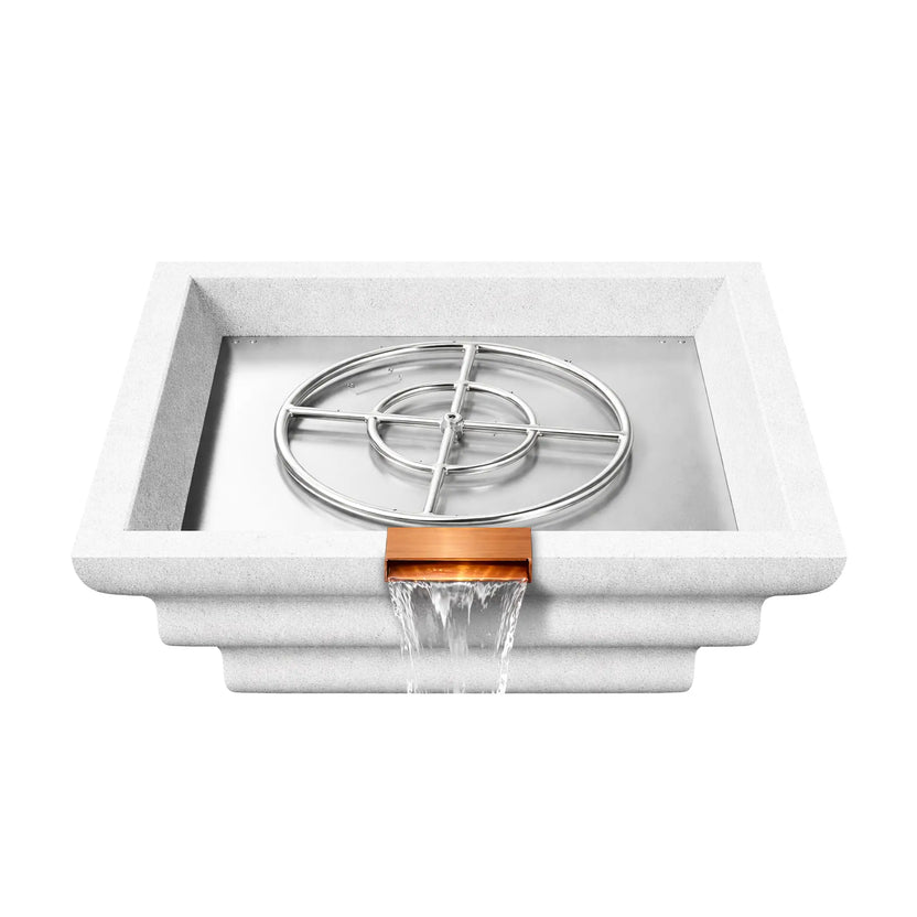 Overhead product view of a white Shadow Cast Ripple fire and water bowl with the stainless steel burner ring assembly exposed in the metal burner tray. The interior basin is empty of fire media while water pours from the copper waterfall spillway, revealing the internal gas fire feature components.
