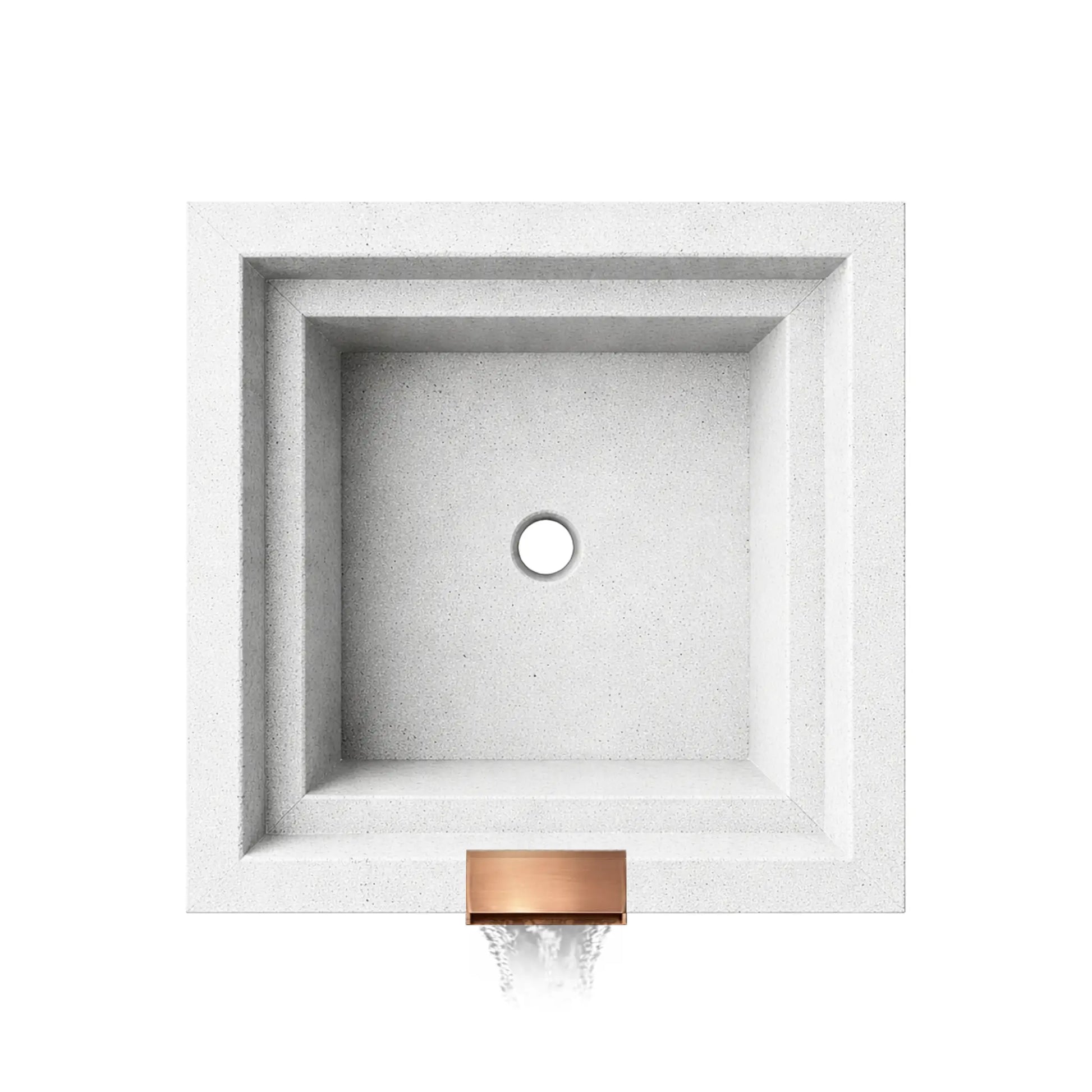 Overhead view of a white Shadow Cast Ripple Designer Series fire and water bowl by Flame Havens, shown empty to highlight the interior basin design. The square GFRC concrete bowl features stepped interior walls and a centered drain opening at the bottom. At the front edge, a copper waterfall spillway releases a smooth sheet of water, illustrating the integrated water feature before the burner and media are installed.
