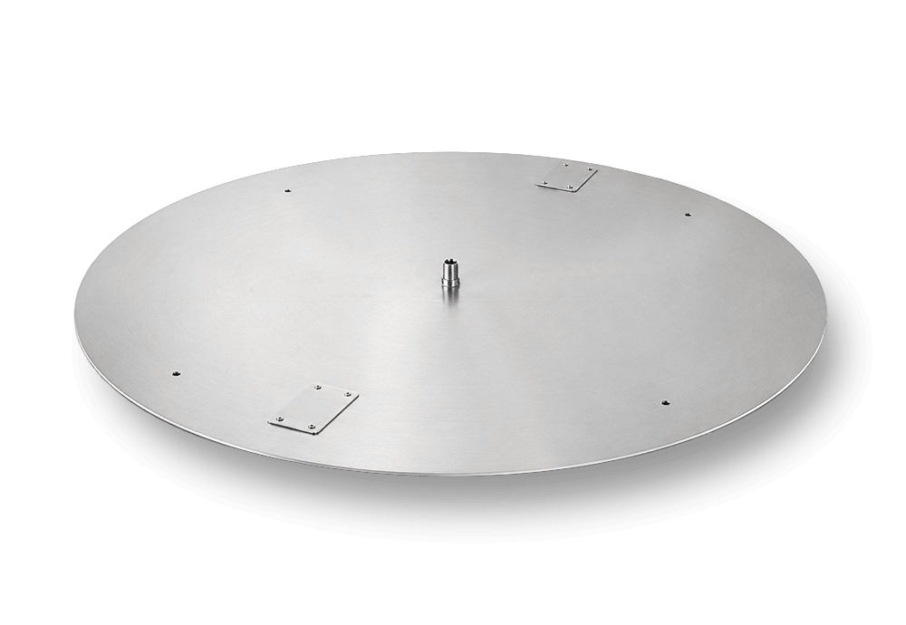 Flame Havens round fire pit burner pan made from brushed stainless steel with a center gas inlet, evenly positioned weep and drain holes, and two removable ignition cover plates. The circular flat-pan design is intended for custom round fire pit burner assemblies and specialty outdoor fire feature fabrication.