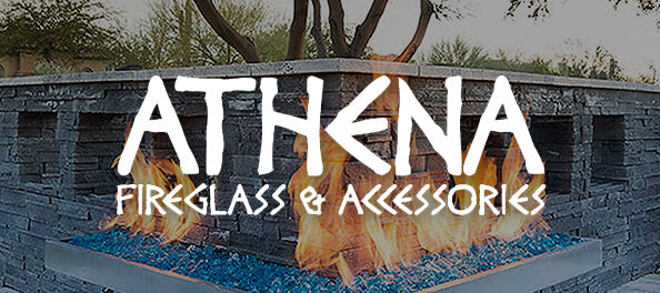 A large white 'ATHENA' logo with 'FIREGLASS & ACCESSORIES' underneath is overlaid on a photo of a modern outdoor fire pit with blue glass stones and flames, set against a dark stone wall.
